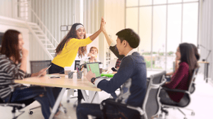 team at a startup company giving each other a high five