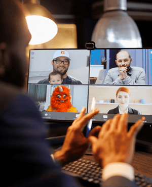 Team meeing on Zoom call, including an orange monster and Orange Pegs' CEO